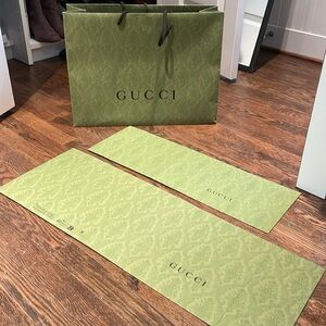 One authentic Gucci shopping bag and two authentic Gucci boxes